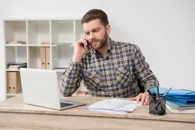 man calling Laurel Bush Family Dentistry to schedule a dental appointment
